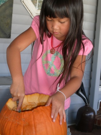 Kasen cleaning out the pumpkin